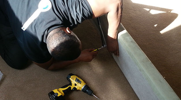 Dismantle the bed. Gladiator removal man dismantaling a bed.